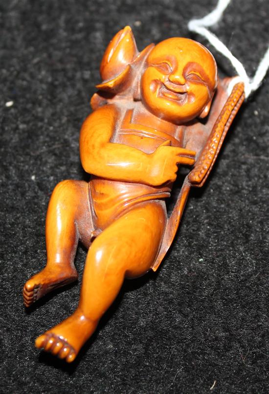 Chinese carved ivory figure of a laughing child with a water lily